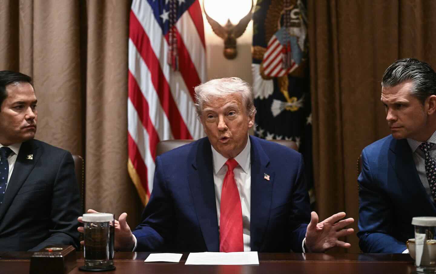 President Donald Trump, alongside Secretary of State Marco Rubio (L) and Secretary of Defense Pete Hegseth (R), speaks during a cabinet meeting on April 10, 2025, in Washington, DC.