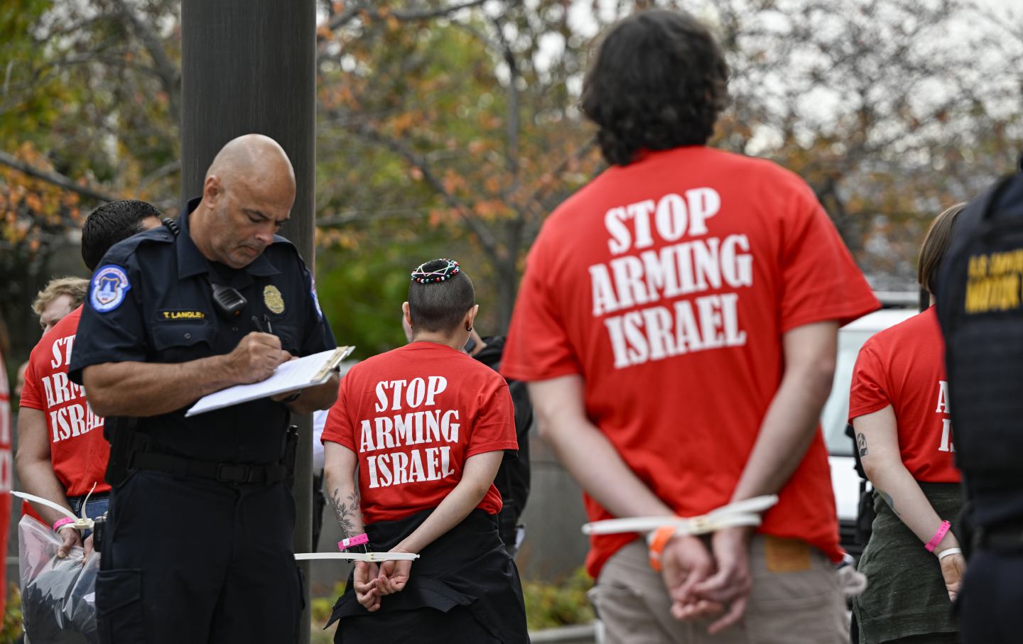 Police detain protesters wearing shirts with the slogan “Stop Arming Israel” during a Pro-Palestinian demonstration in Washington, DC, on November 19, 2024.